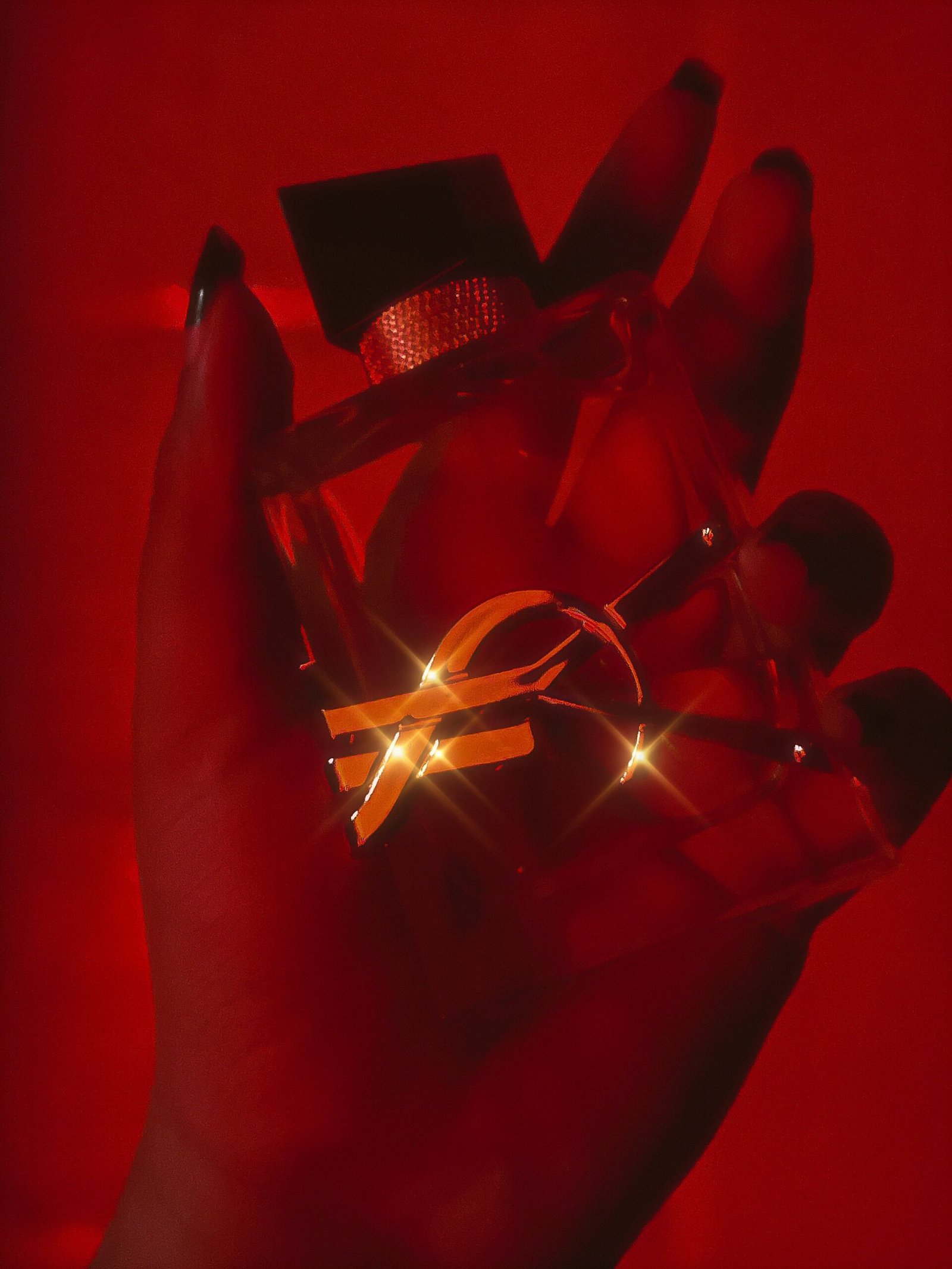 A person's hand holding a lit up object